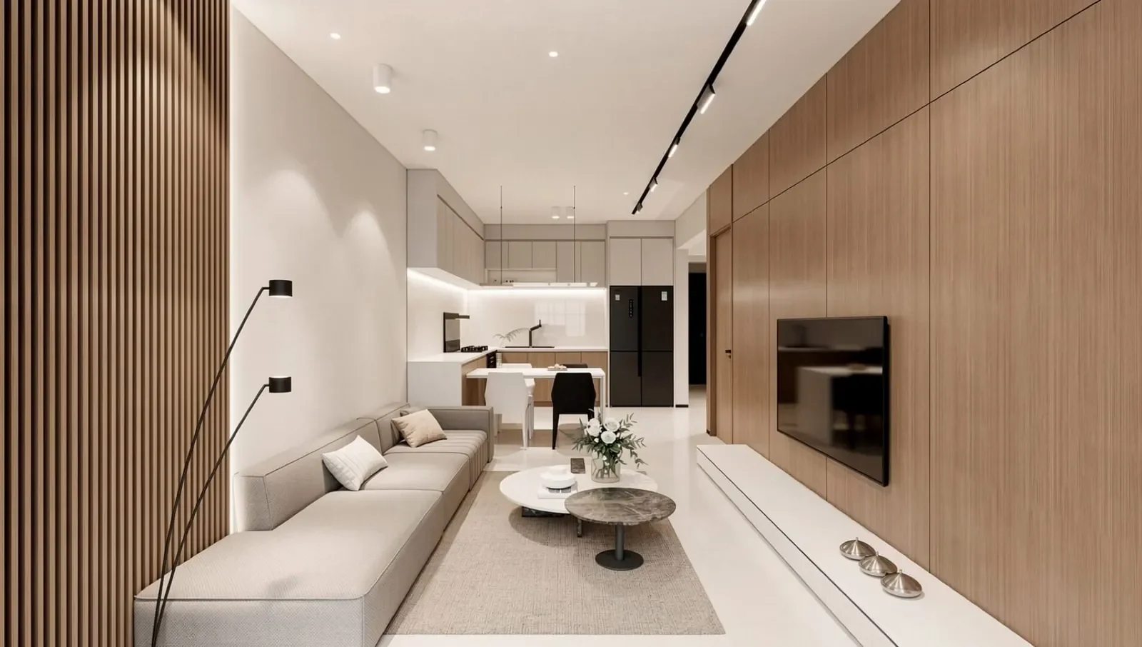 Avana Oasis Residency interior rendering showing a grey sofa, wall-mounted TV and open-plan dining area and kitchen.