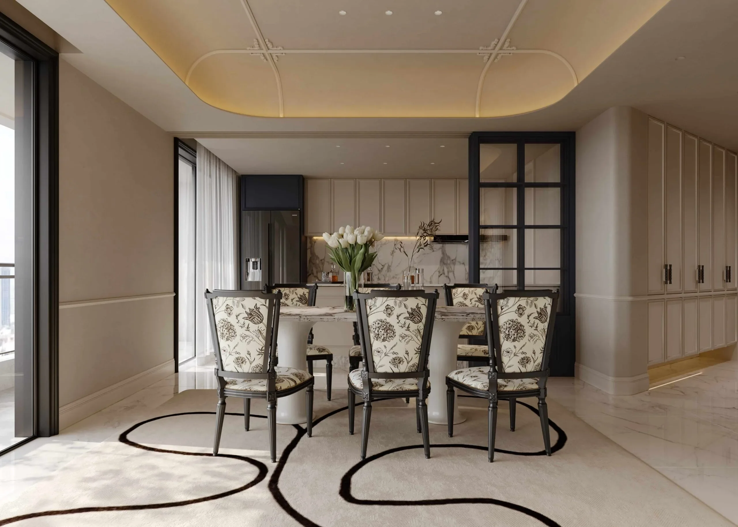 Dining area at Brookside Oak Residency with floral-upholstered chairs, a flower-topped table and kitchen beyond.