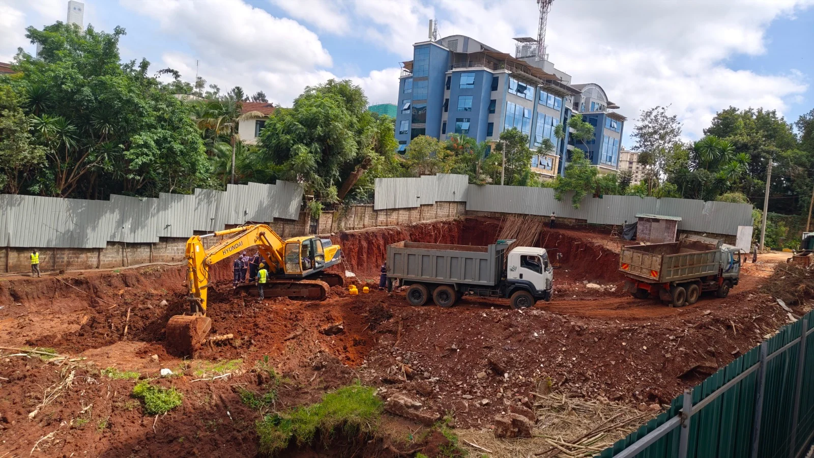 Excavator, two tipper trucks and workers at the Calla Residency excavation site in Westlands, Nairobi.