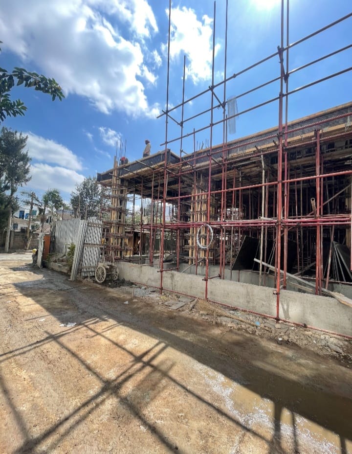 Scaffolding and timber formwork support an unfinished structure at the Capital Vista construction site in Kilimani.