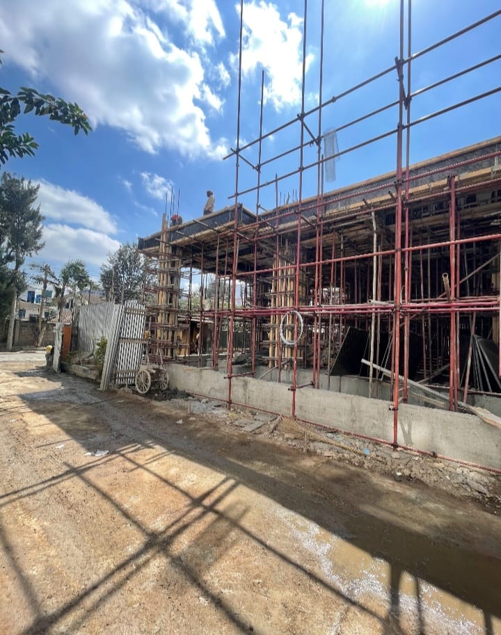 Capital Vista construction site in Kilimani with scaffolding and timber formwork around an unfinished concrete structure.