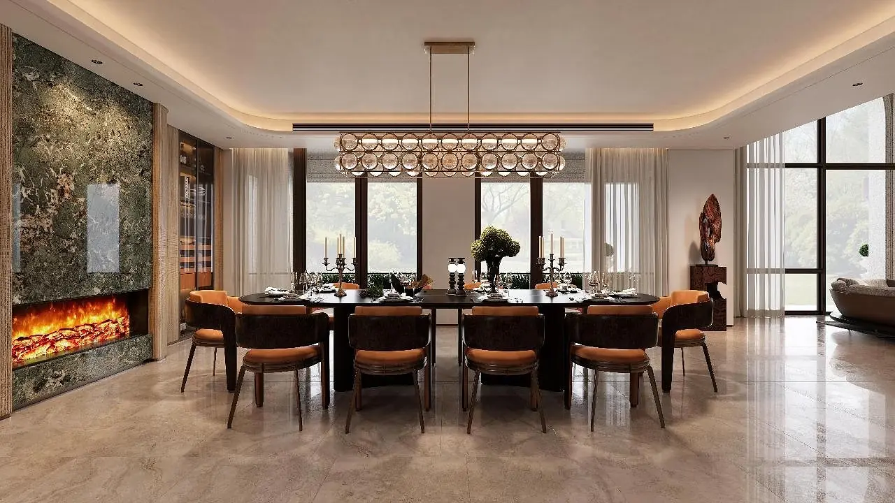 Dining room at Cartier Villas Runda with a long table, ring chandelier and lit fireplace.