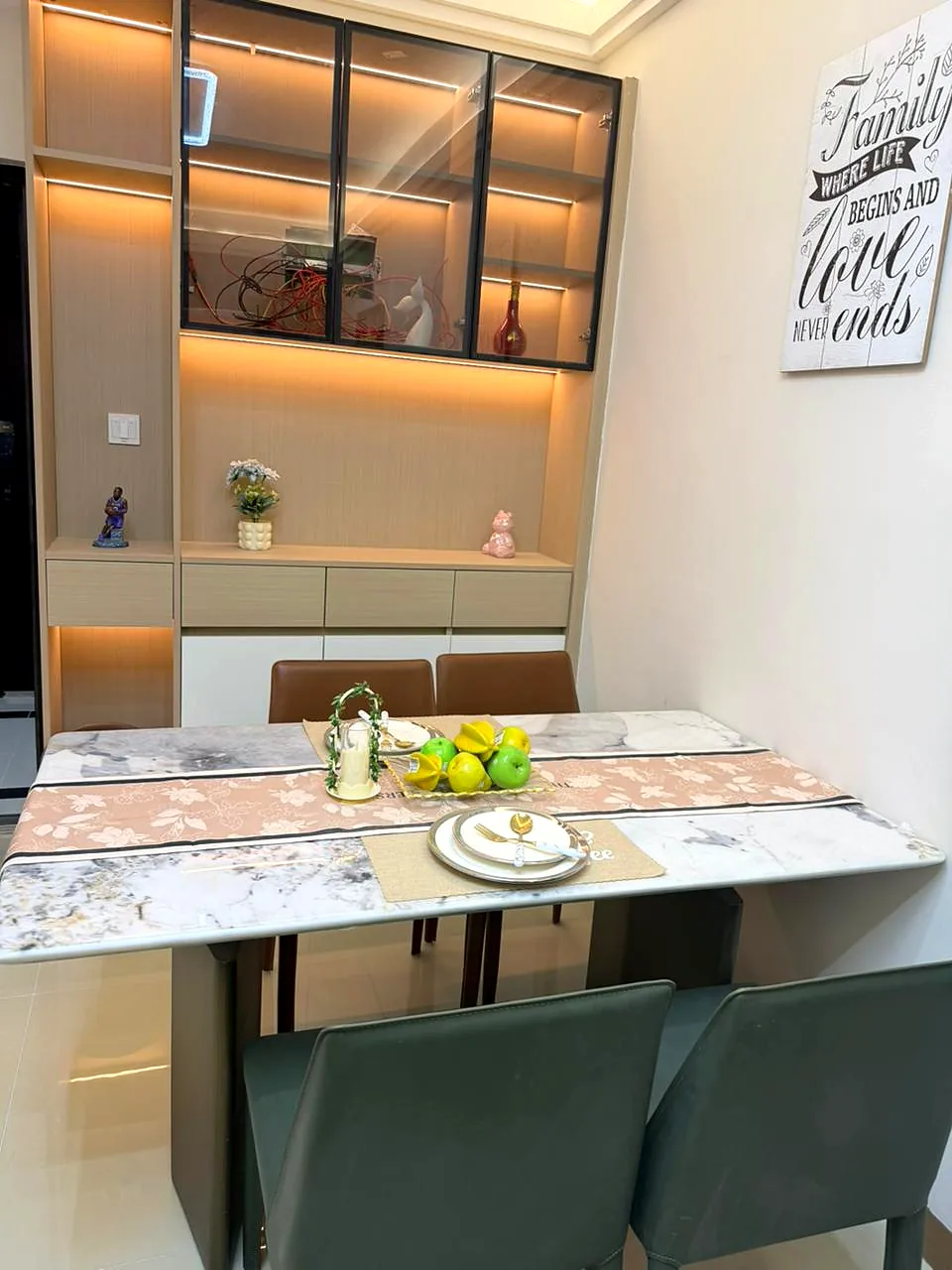 Dining area at Lido Garden, Kilimani, with green chairs, a set table and illuminated glass-front cabinets.