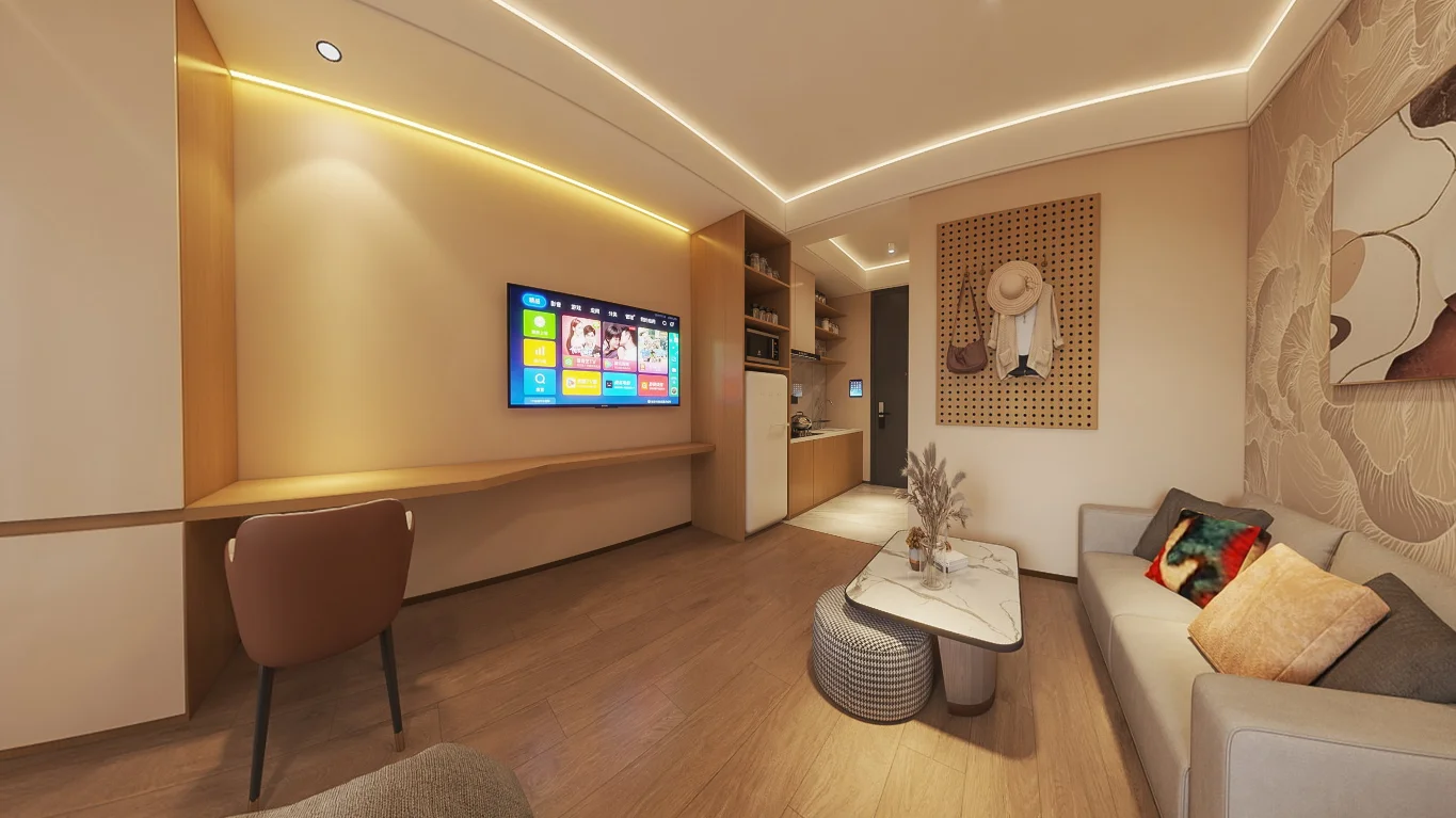 Living area at Longines Bay, Kilimani, with a sofa, wall-mounted TV, built-in desk and kitchenette.