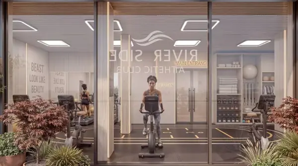 Gym rendering at Riverside Times Apartments, showing stationary bikes behind glass and potted plants outside.