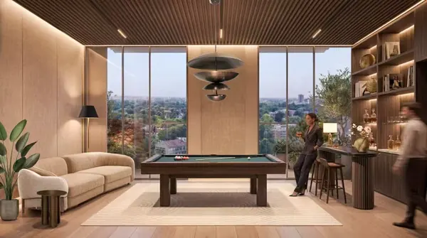 Lounge rendering with a pool table, sofa and large windows at Riverside Times Apartments.