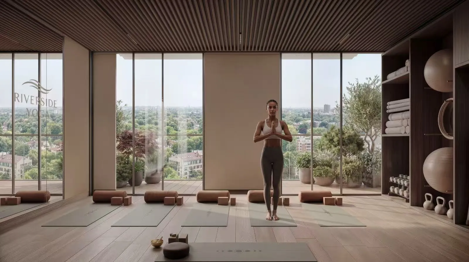 Yoga studio rendering at Riverside Times Apartments, with a woman practising yoga, exercise mats and floor-to-ceiling windows.
