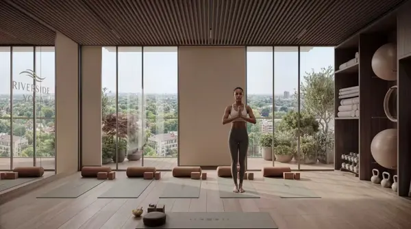 Yoga studio rendering at Riverside Times Apartments, with a person practising yoga, exercise mats and full-height windows.