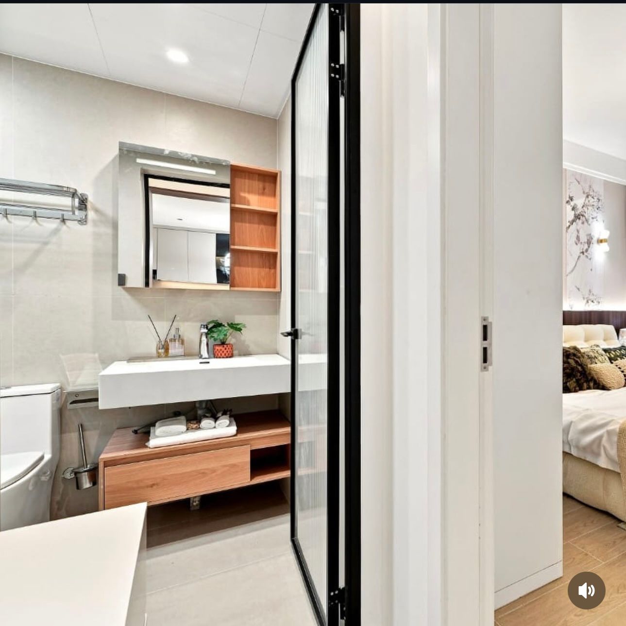 Bathroom at Santorini Residences, Westlands, with a rectangular basin, wall mirror, open shelving and toilet.
