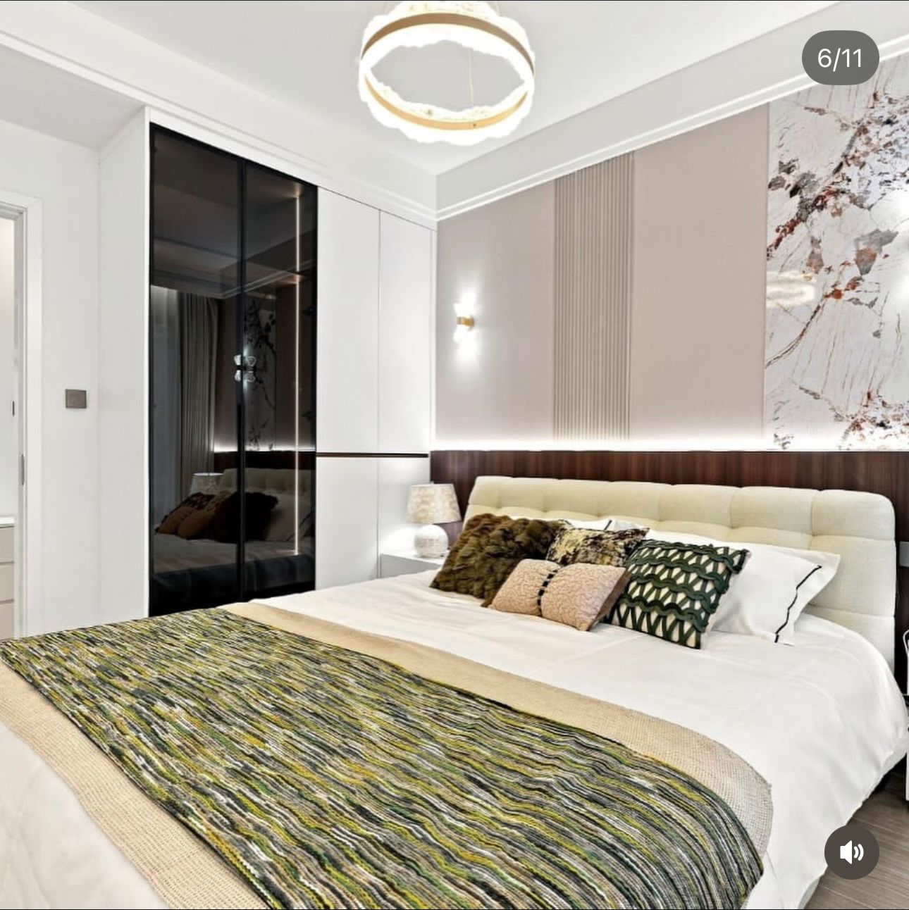Bedroom at Santorini Residences, Westlands, with an upholstered headboard, patterned bedding and mirrored wardrobe.
