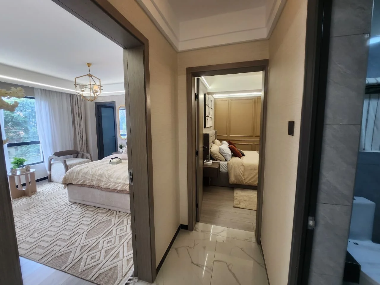 Hallway opening onto two furnished bedrooms and a bathroom at Super Westbury Apartments in Westlands.