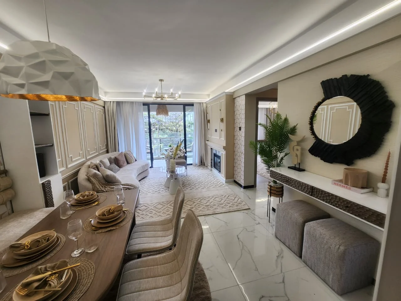 Open-plan living and dining area at Super Westbury, Westlands, with a set table, sofa and balcony doors.
