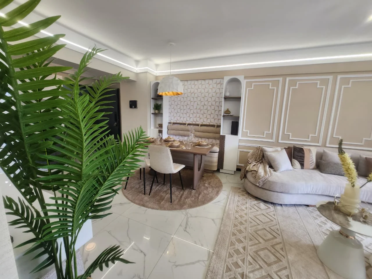 Super Westbury living and dining area with a curved sofa, set dining table and pendant light.