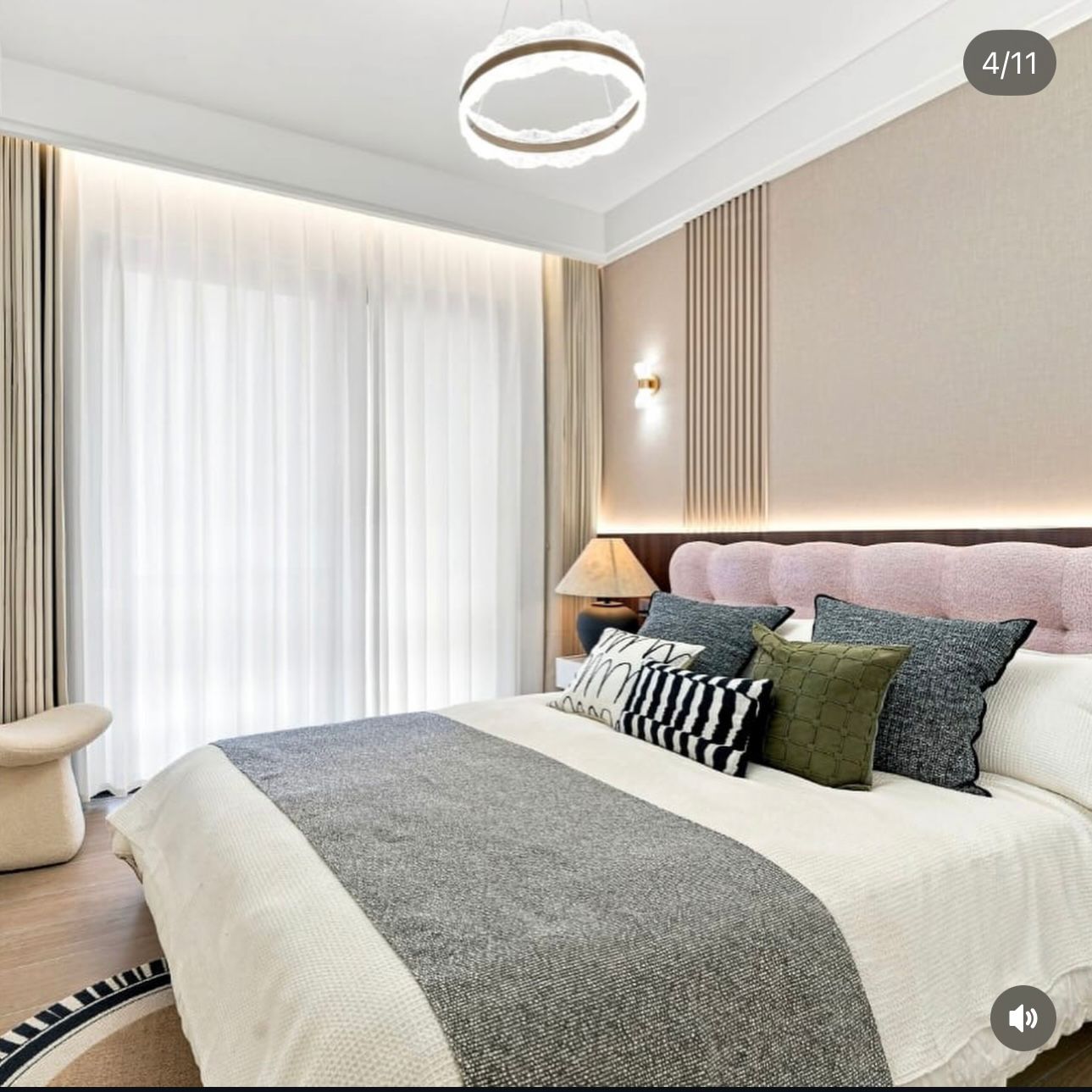 Bedroom at Ubora Living, Westlands, with a pink upholstered headboard, patterned cushions and floor-to-ceiling sheer curtains.
