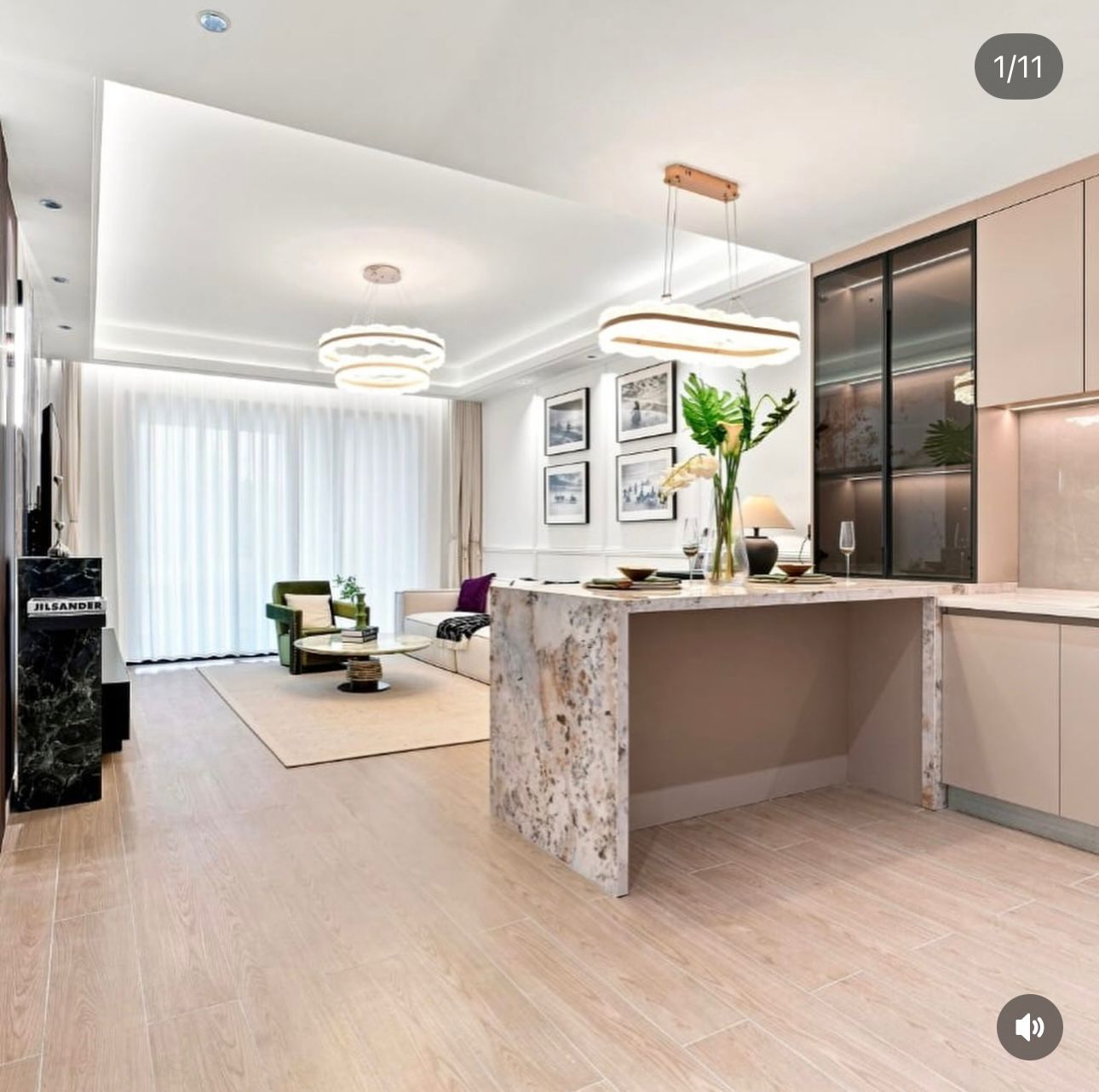 Open-plan living area at Ubora Living, Westlands, with a breakfast counter, pendant lights and a green armchair.